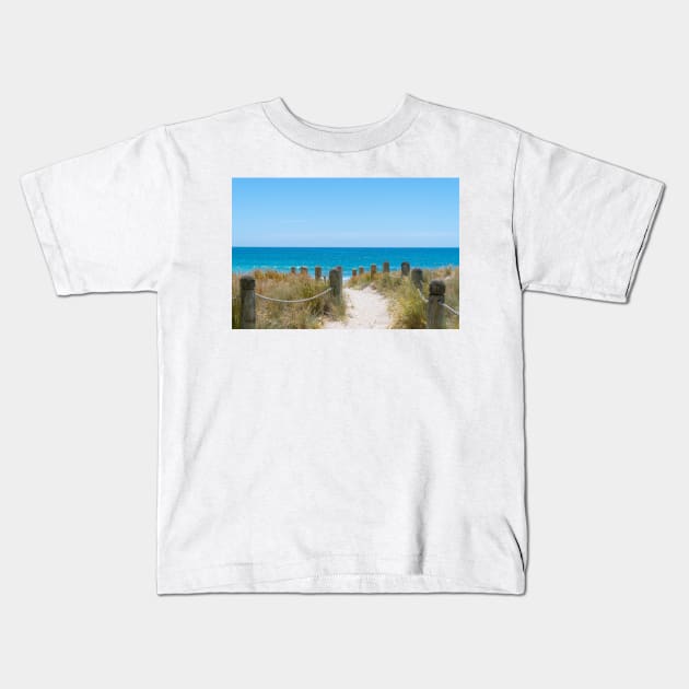 Bollards and ropes line sand track through dunes to Main Beach Mount Maunganui Kids T-Shirt by brians101